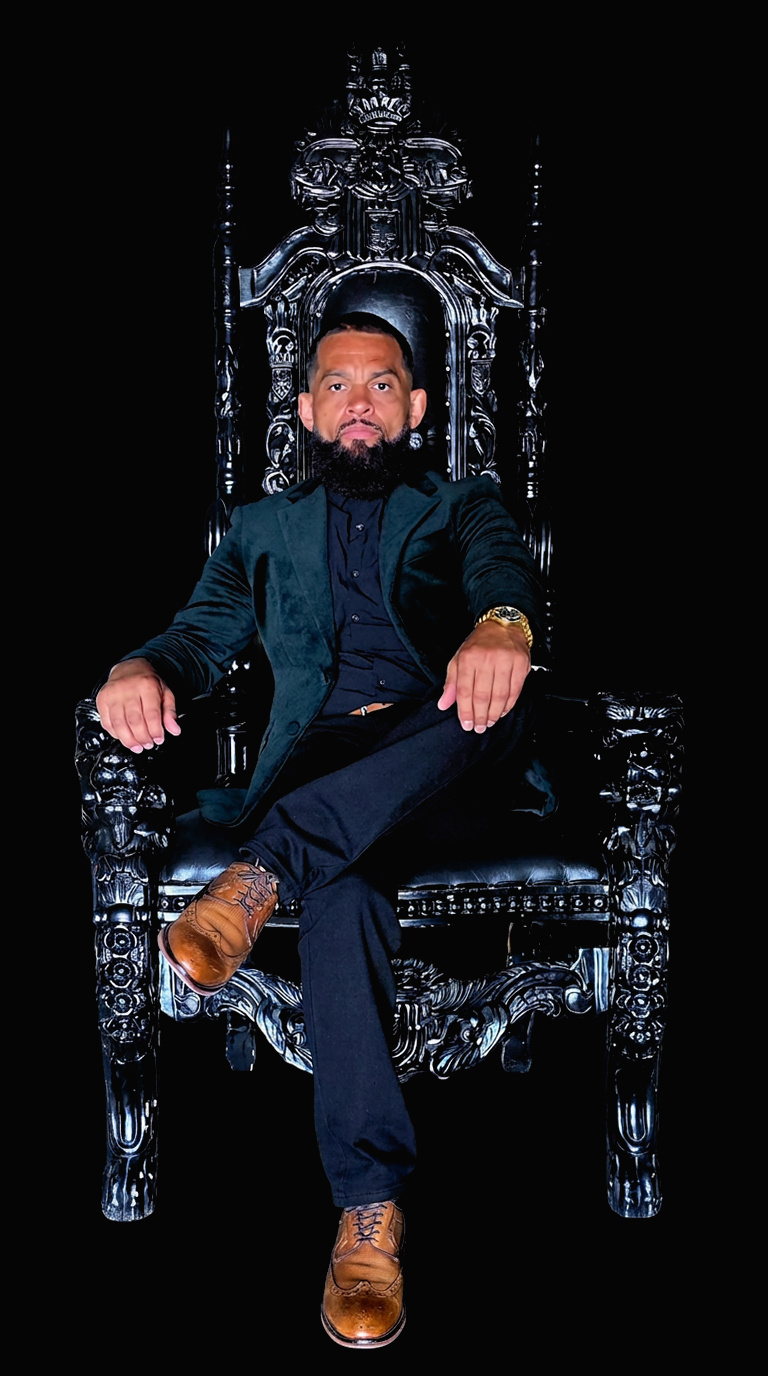 Nickie Stone seated on a throne